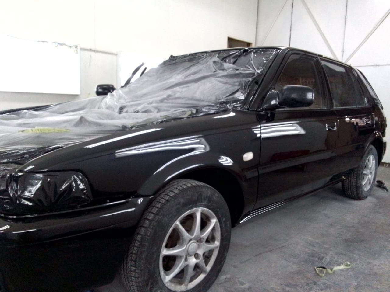 Deep, glossy black panels after a colour-matched respray at KMB