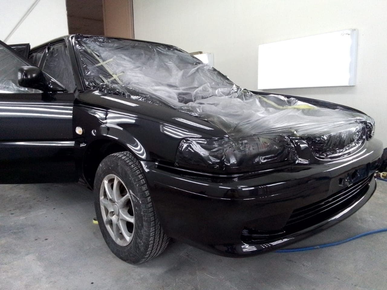 Black sedan finished to a deep, glossy shine